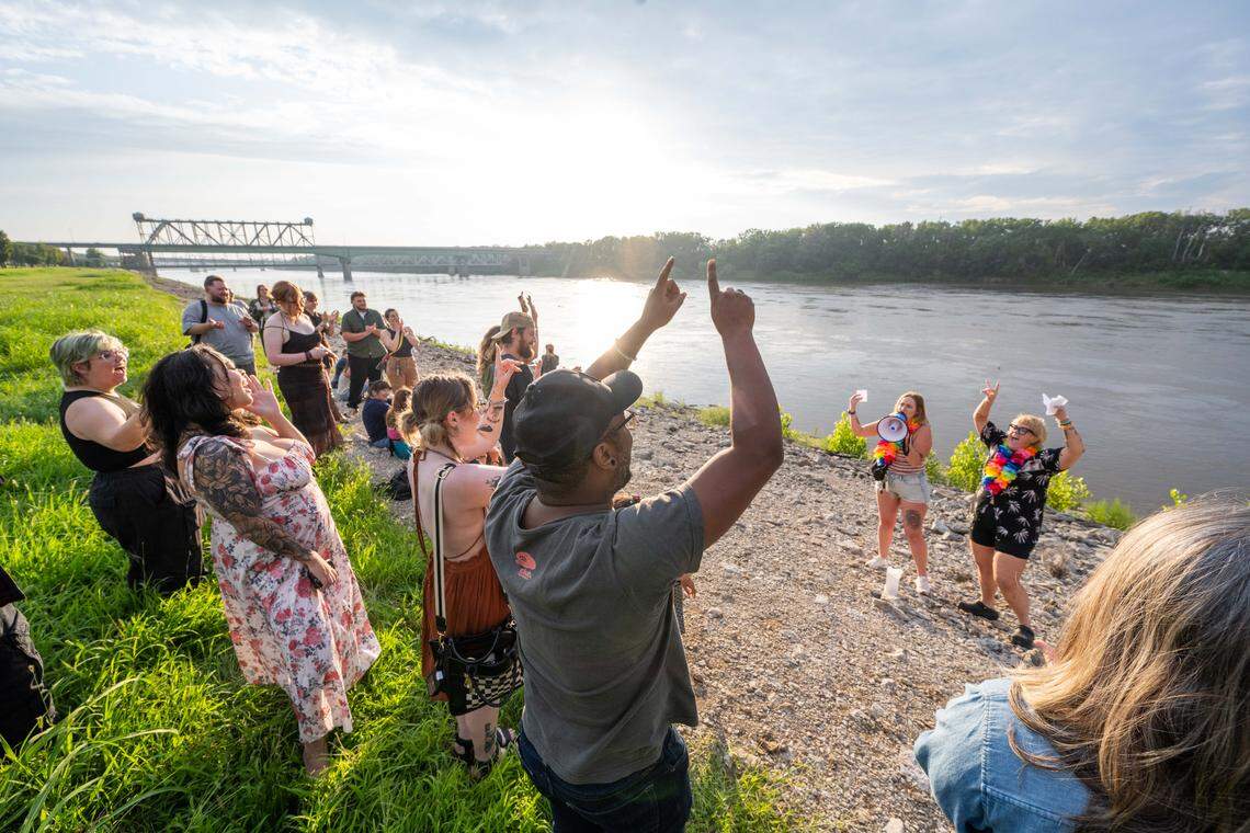 Participants of the initial meeting of the Scream Club scream while they celebrate collective wins on the banks of the Missouri River on Sunday, Aug. 3, 2025 in Kansas City. The group, inspired by a viral trending video of a ‘scream club’ in Chicago, plans to meet once a week on Sundays at Berkley Riverfront Park to scream out their frustrations, celebrate life wins, and build community.