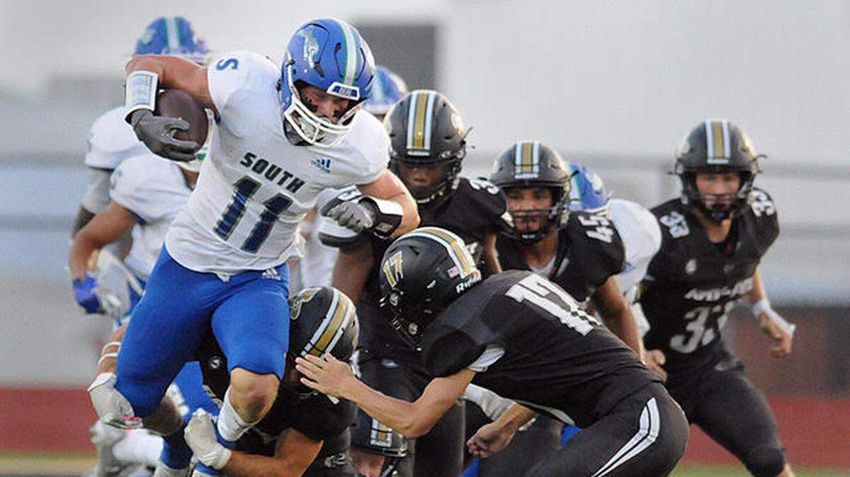 Blue Springs South’s Jack Brickhouse breaks a tackle during the first half of South’s 52-34 win over Raymore-Peculiar on Friday night.