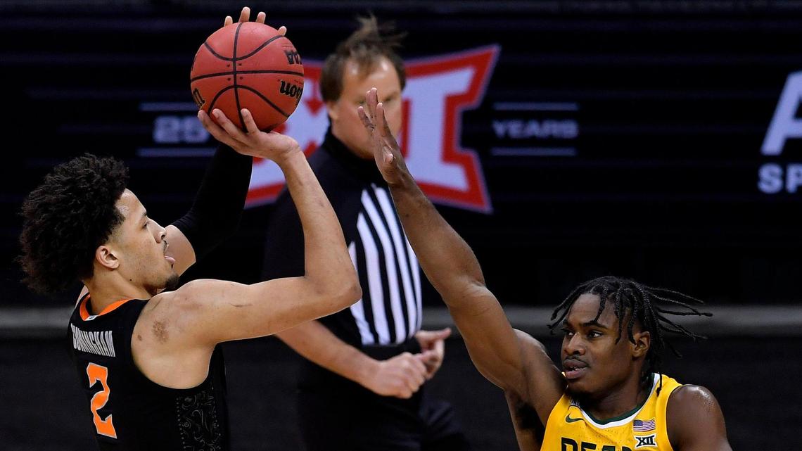 OSU’s Cade Cunningham, left, shoots over Baylor’s Davion Mitchell during the first half of a Big 12 Tournament semifinal game Friday night, March 12, 2021, at the T-Mobile Center in Kansas City.