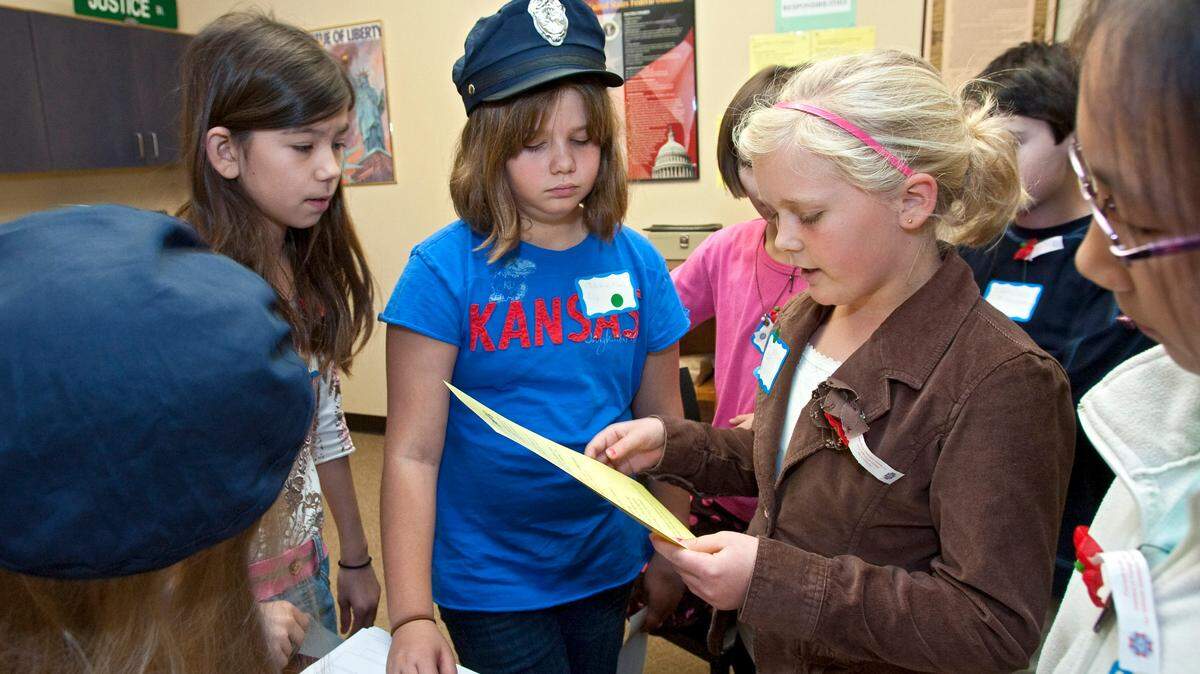 In 2009, a student from Briarwood Elementary School who was playing a mayor gathers her city workers together during a civics day for fifth graders at Exchange City.