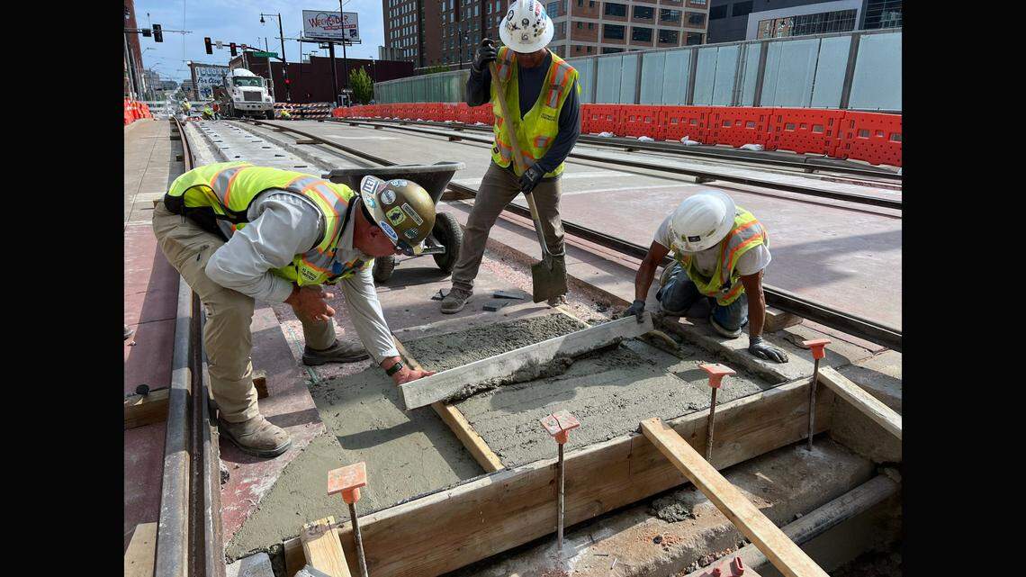 Crews smooth out concrete Wednesday evening as they make repairs to Kansas City Streetcar tracks after a rail buckled on the Main Street bridge over Interstate 670 on Independence Day, forcing the agency to abruptly suspend service. The work was being done in preparation for resetting the rails on Thursday.