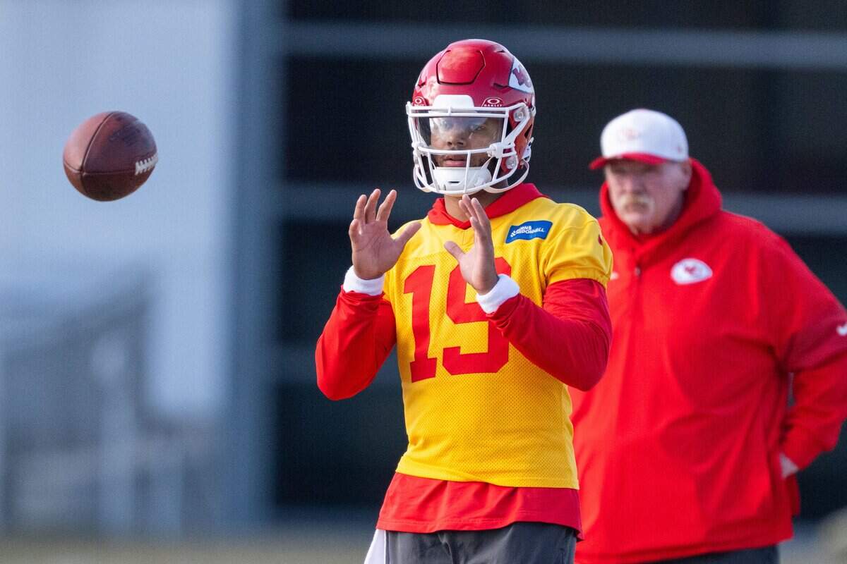 Kansas City Chiefs quarterback Chris Oladokun (19) catches a ball while head coach Andy Reid watches behind him, during Chiefs practice on Tuesday, December 23, 2025.