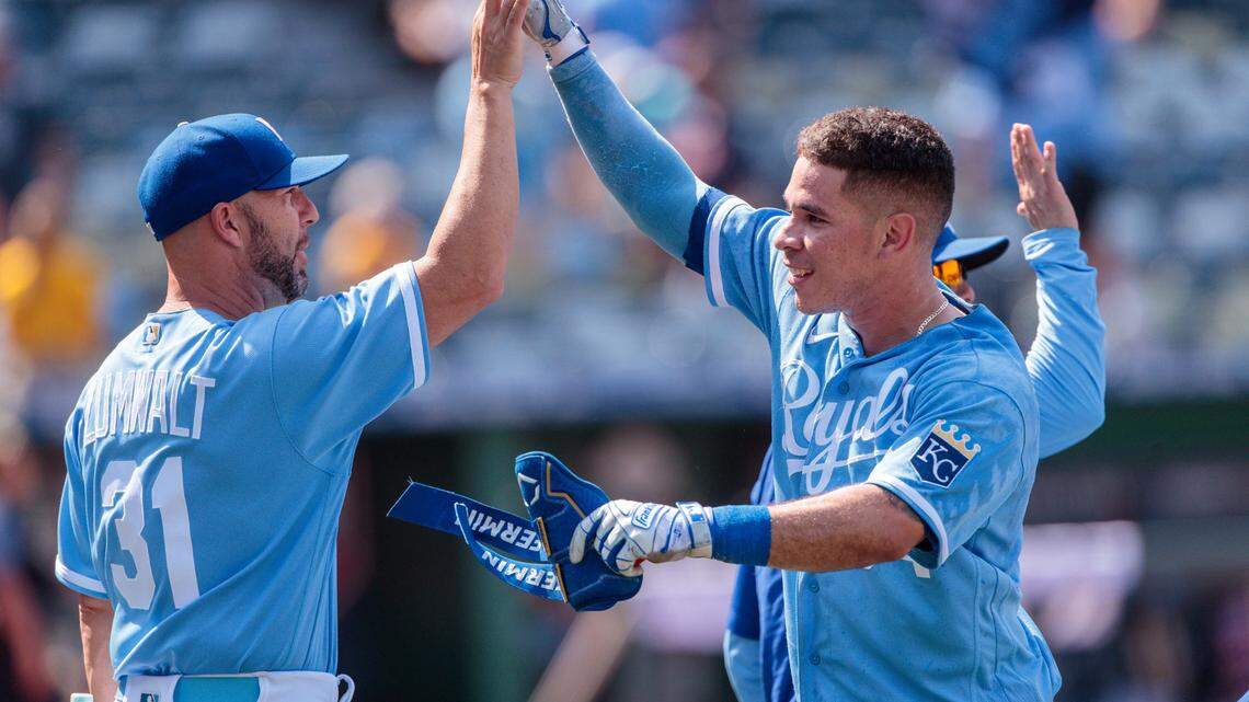 Kansas City Royals catcher Freddy Fermin (34) high fives Kansas City Royals senior director of hitting performance, major league hitting coach Alec Zumwalt (31) after a walk off during the tenth inning against the Cleveland Guardians at Kauffman Stadium.