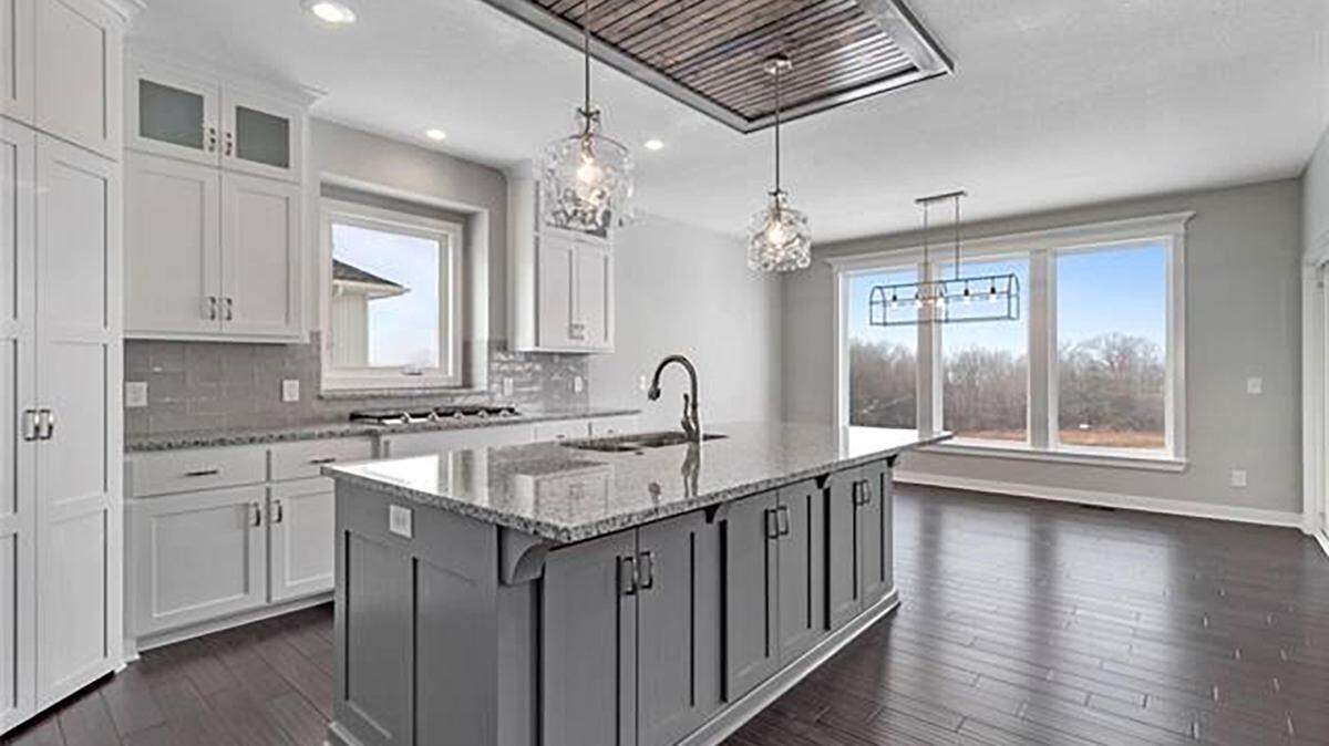 The Taft plan by Patriot Homes, a four bed, three bath, reverse story and a half, offers luxurious finishes and abundant storage in the open kitchen.