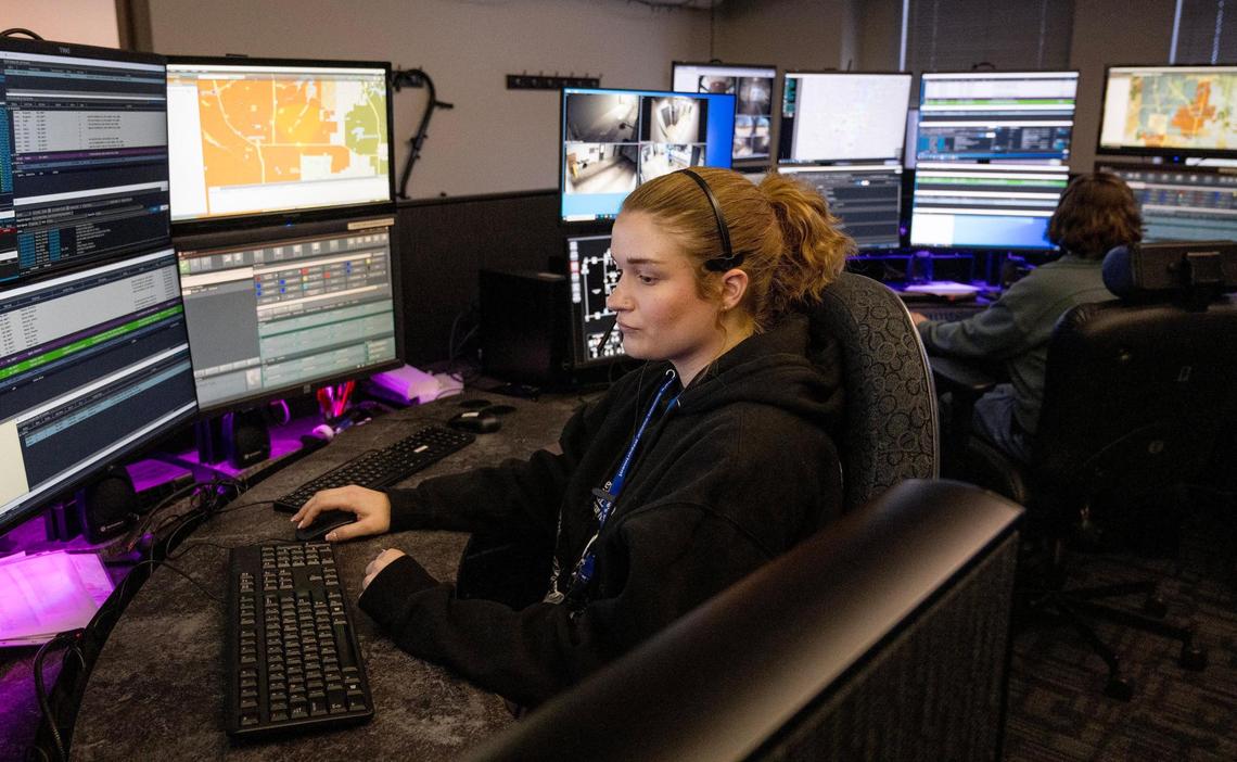 Payton Florine, a communications specialist in training with Lee’s Summit police, demonstrates how dispatchers monitor computers.