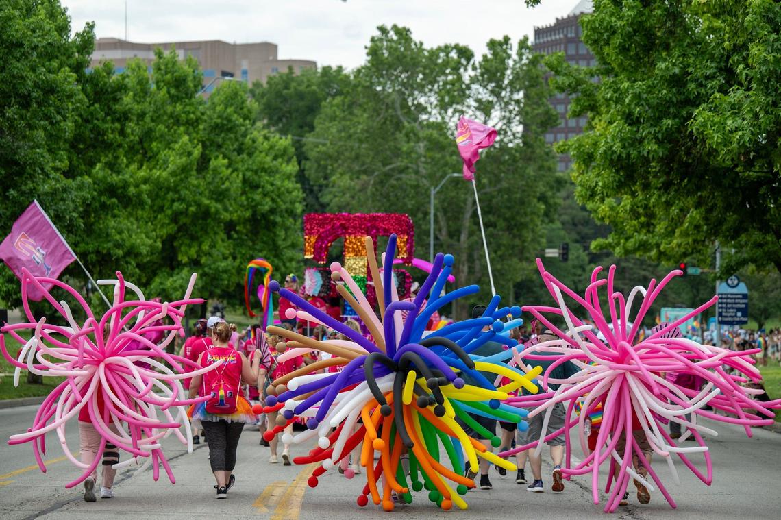 Participants wore balloons as they walked down Broadway following the T-Mobile float during the KC Pride Parade.