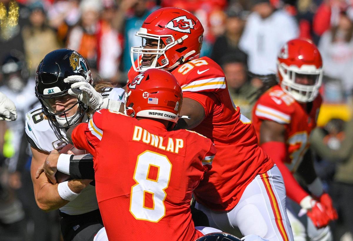 Kansas City Chiefs defensive end Carlos Dunlap (8) and defensive tackle Chris Jones (95) sack Jacksonville Jaguars quarterback Trevor Lawrence (16) during the first half on Sunday, Nov. 13, 2022, at Arrowhead Stadium in Kansas City.