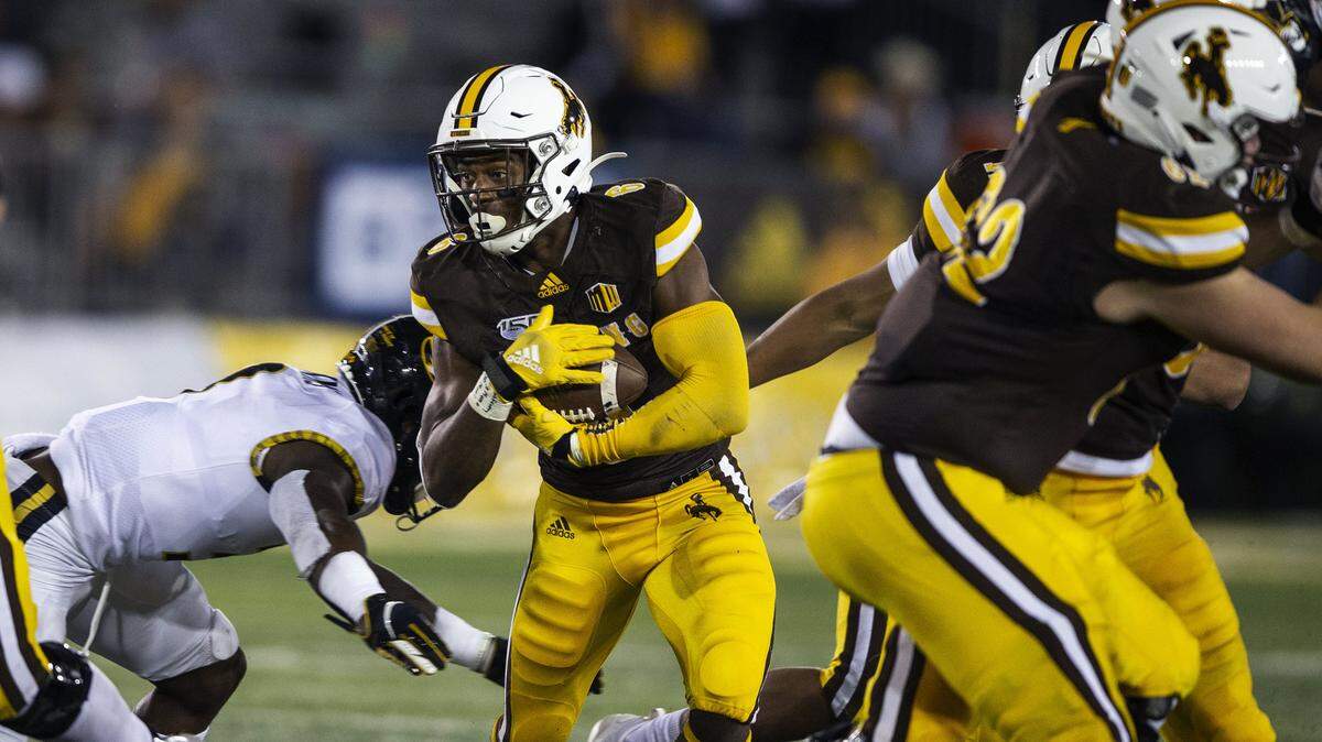 Wyoming’s Xazavian Valladay runs for yardage during the fourth quarter against Missouri during an NCAA college football game, Saturday, Aug. 31, 2019, in Laramie, Wyo. (AP Photo/Michael Smith)