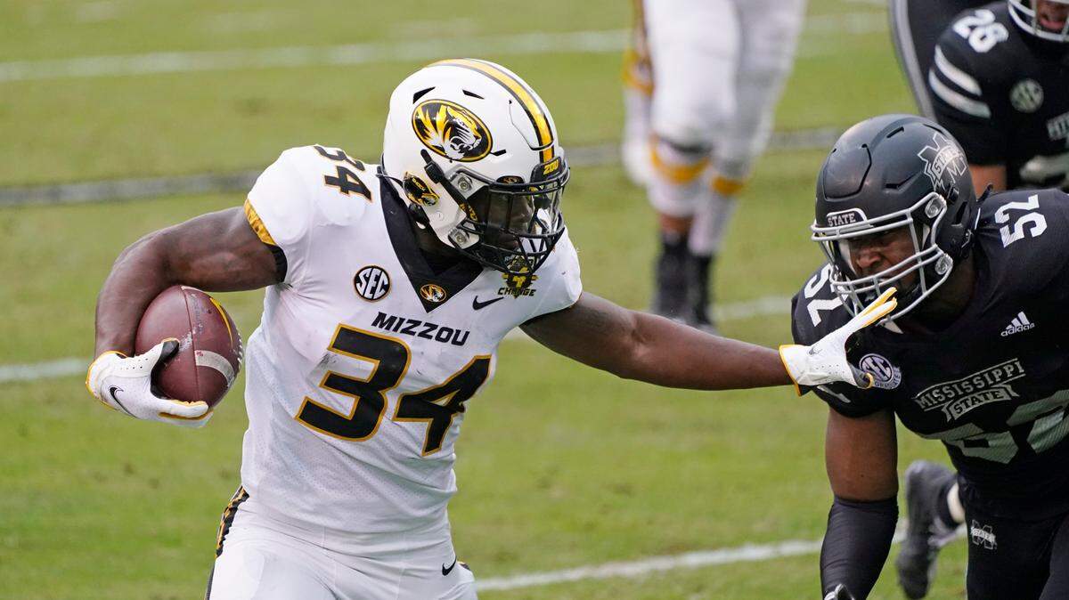 Missouri running back Larry Rountree III (left) fights off Mississippi State defensive end Kobe Jones on his way to a 18-yard touchdown run on Saturday, Dec. 19, 2019, in Starkville, Miss.