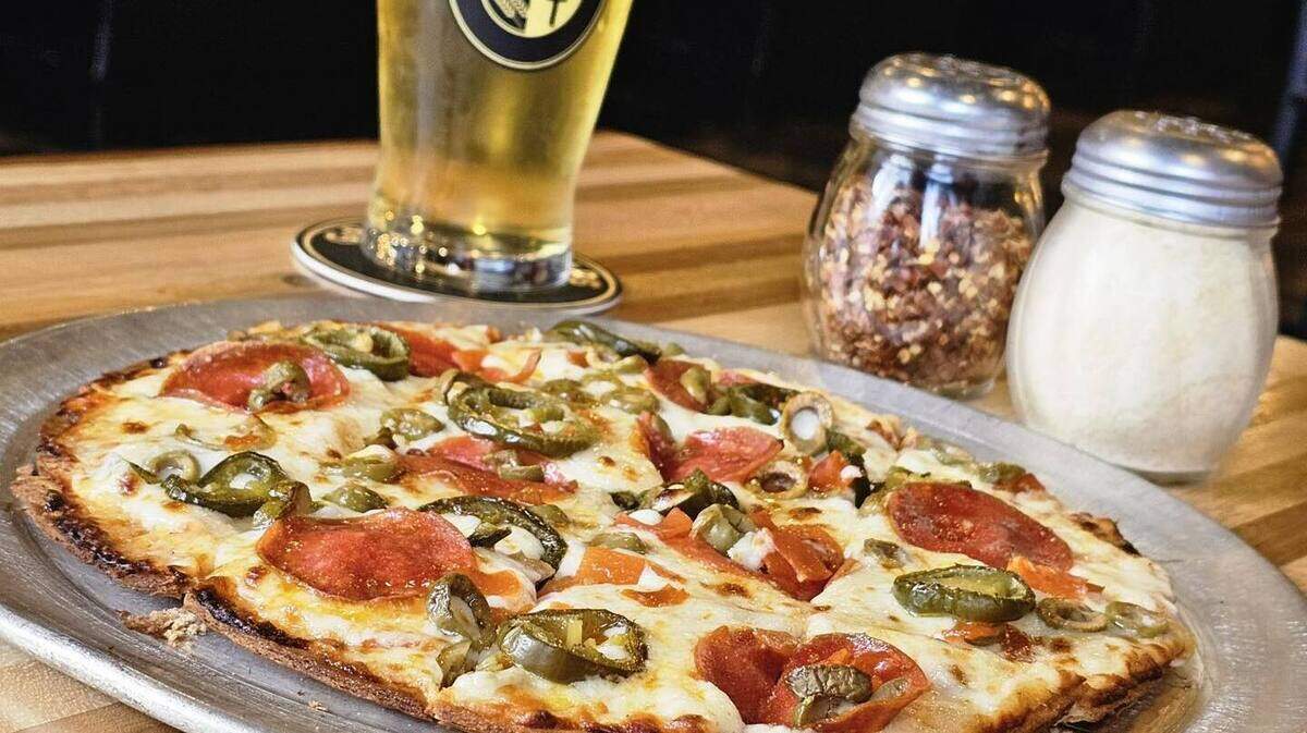 The local taproom’s menu features pizza, appetizers and salads as well as beer, wine and cocktails.