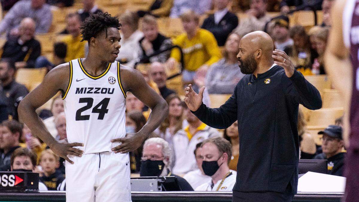 Missouri head coach Cuonzo Martin, right, talks to Kobe Brown, left, during a timeout in the second half of an NCAA college basketball game against Texas A&M Saturday, Jan. 15, 2022, in Columbia, Mo. Texas A&M won 67-64. (AP Photo/L.G. Patterson)