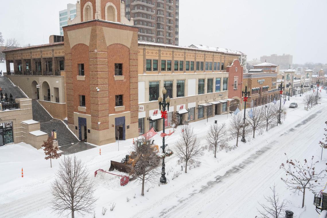 A snow plow runs on 47th Street through the Country Club Plaza in Kansas City on Sunday, Jan. 5, 2025.