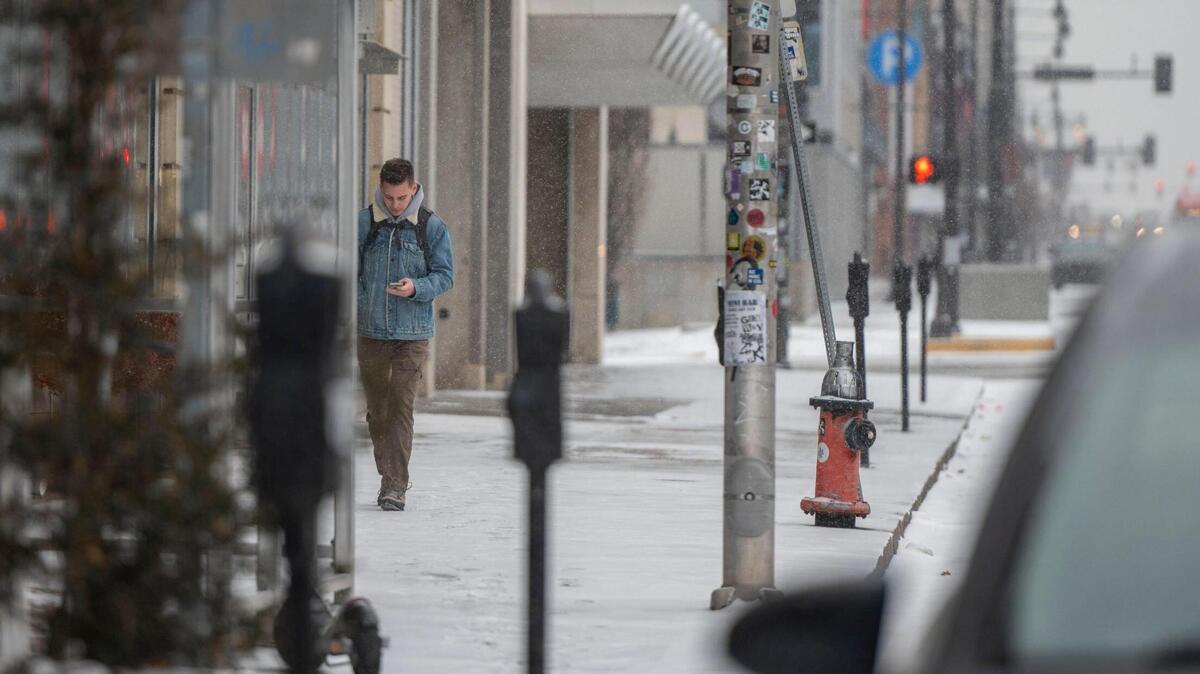 Light snow begins to fall over downtown Kansas City on Thursday, Feb. 24, 2022.