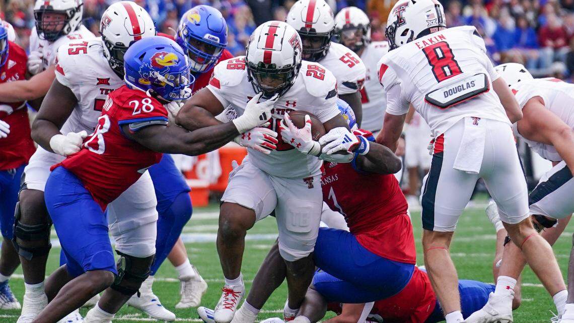 Red Raiders running back Tahj Brooks runs the ball straight ahead against the Kansas Jayhawks on Saturday at David Booth Kansas Memorial Stadium.