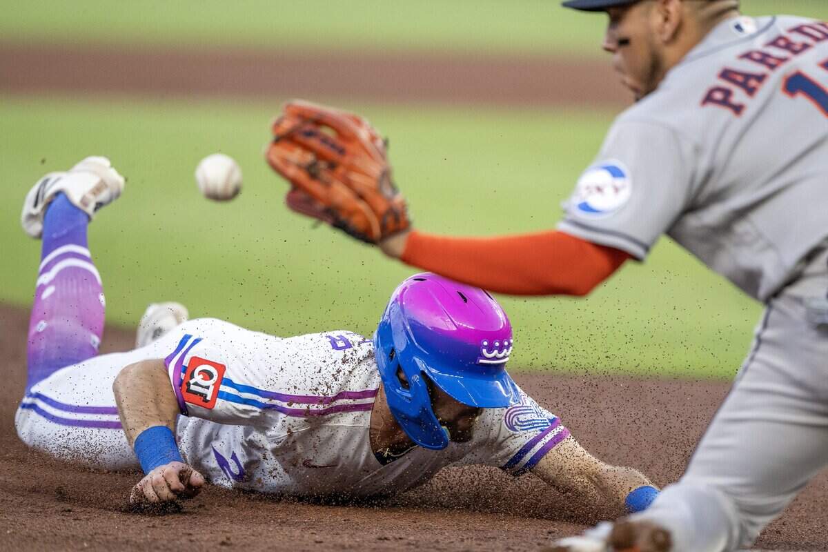 Wearing the Kansas City Royals' new "Forever Fountains" City Connect uniform, center fielder Kameron Misner (26) slides to third base in the first inning against the Houston Astros on Friday, June 12, 2026, at Kauffman Stadium in Kansas City.