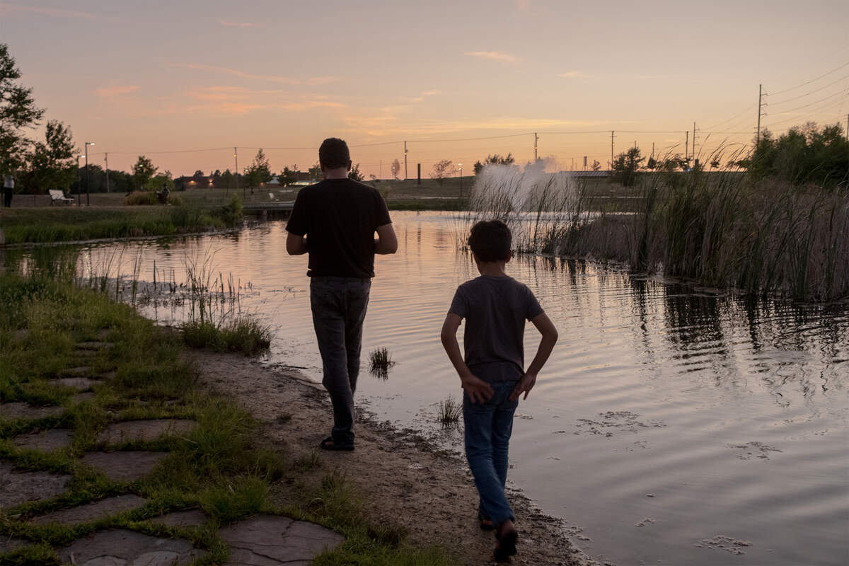 Lemar and a son often go to the local park and feed the fish.