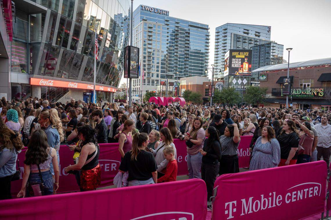 People stand in line outside T-Mobile Center to attend the Jonas 20: Greetings from Your Hometown tour on Tuesday, Oct. 7, 2025, in Kansas City.