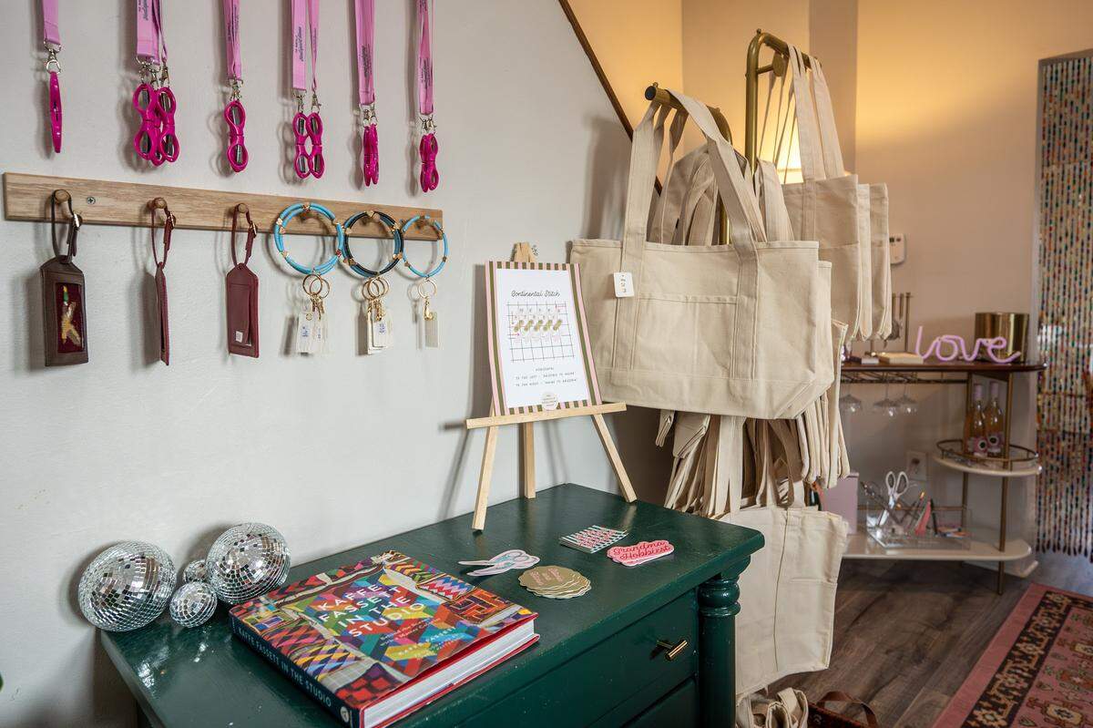 Merchandise is displayed along a wall at the The Parkville Needlepoint House on Wednesday, Feb. 11, 2026, in Parkville.