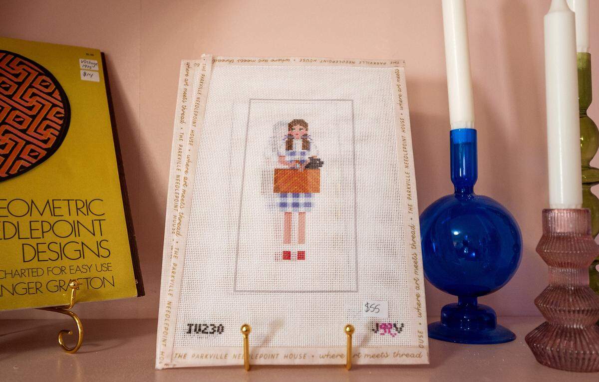 A “Wizard of Oz”-themed needlepoint canvas is displayed for sale on a shelf at The Parkville Needlepoint House on Wednesday, Feb. 11, 2026, in Parkville.