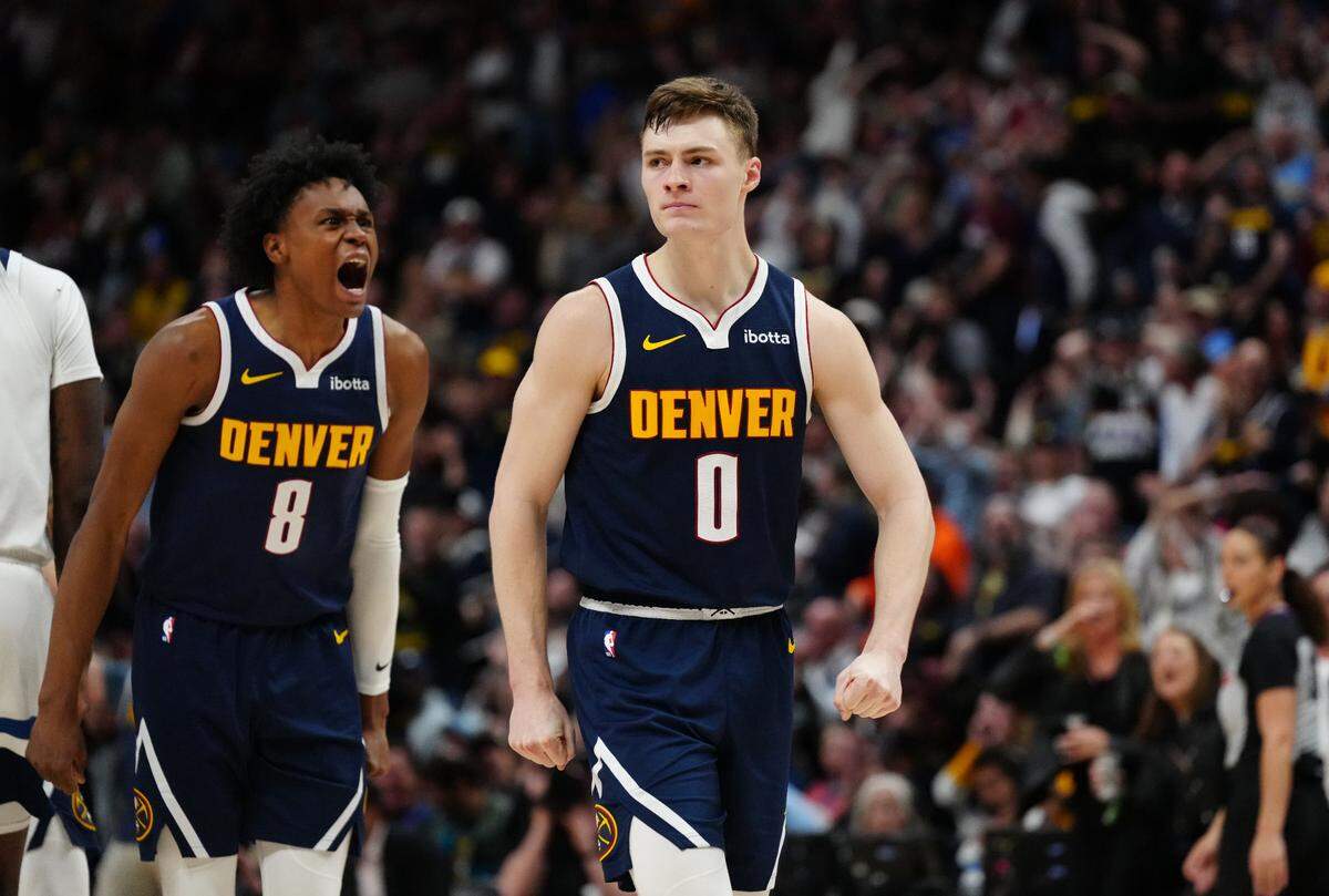 Denver Nuggets guard Christian Braun (0) and forward Peyton Watson (8) react in the fourth quarter against the Minnesota Timberwolves at Ball Arena on April 10, 2024.