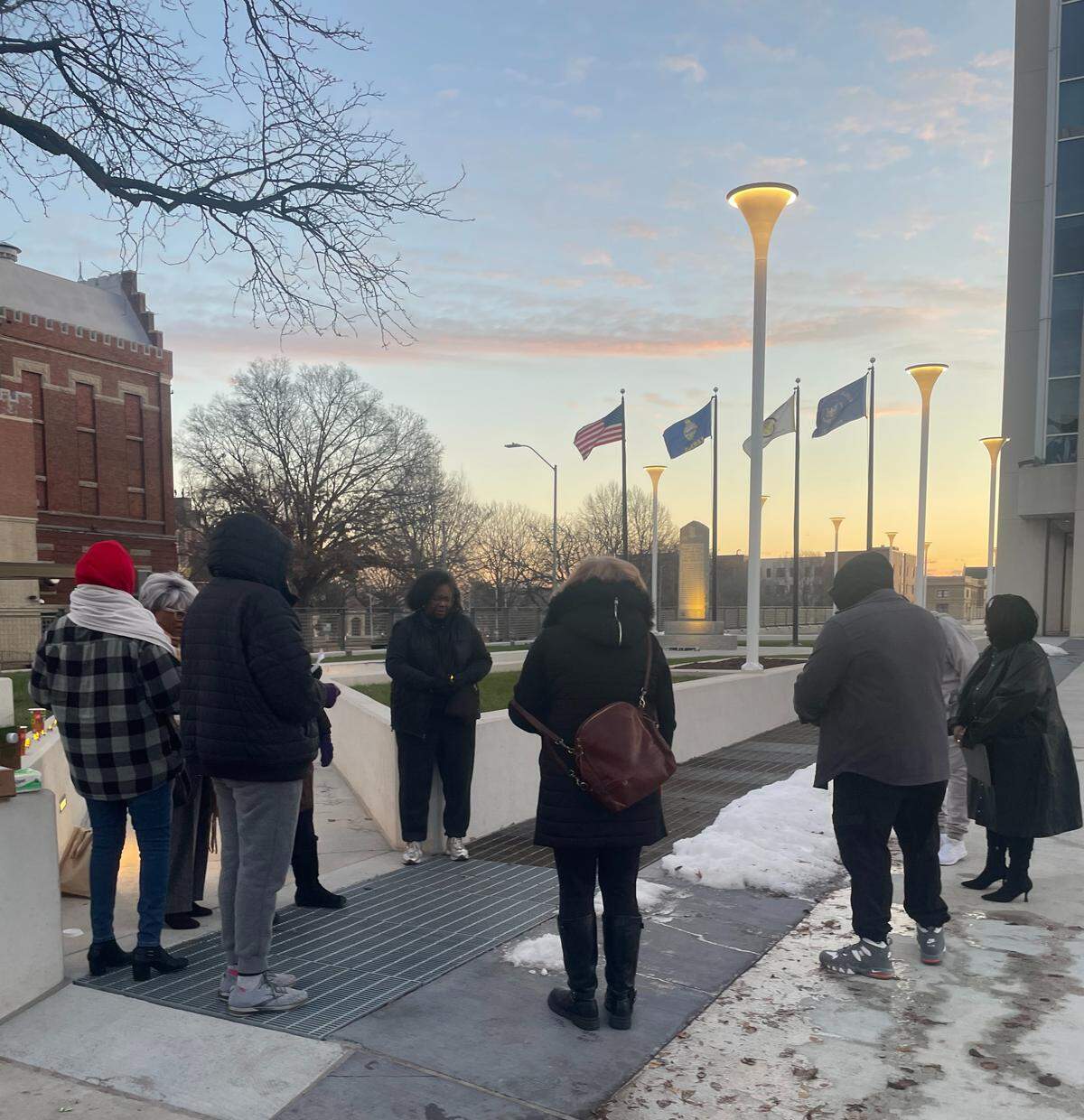People affected by former officer Roger Golubski’s time as a cop in KCK say an opening prayer ahead of their demonstration in downtown KCK on the morning of Dec. 9, 2025.