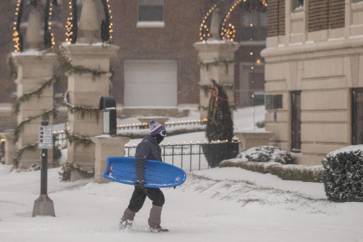 A pedestrian with a sled walks through Country Club Plaza in Kansas City on Sunday, Jan. 5, 2025.