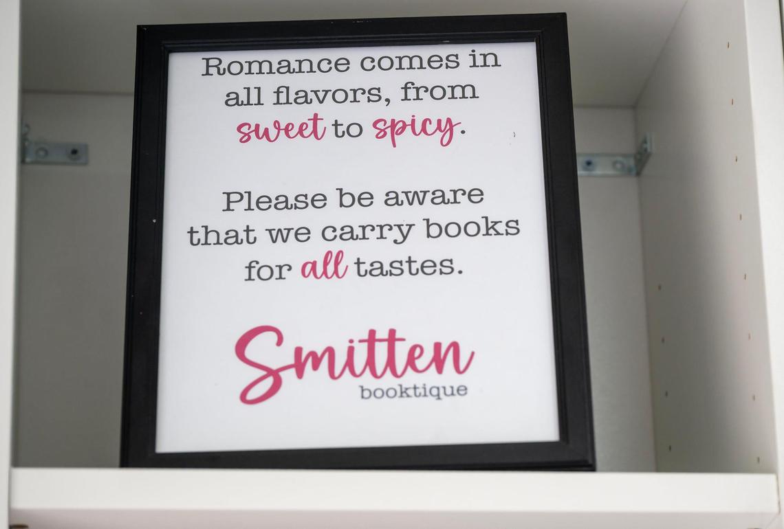 A sign alerting readers to book content from sweet to spicy is available at Smitten Booktique, a mobile bookstore featuring romance novels, on Tuesday in Overland Park.