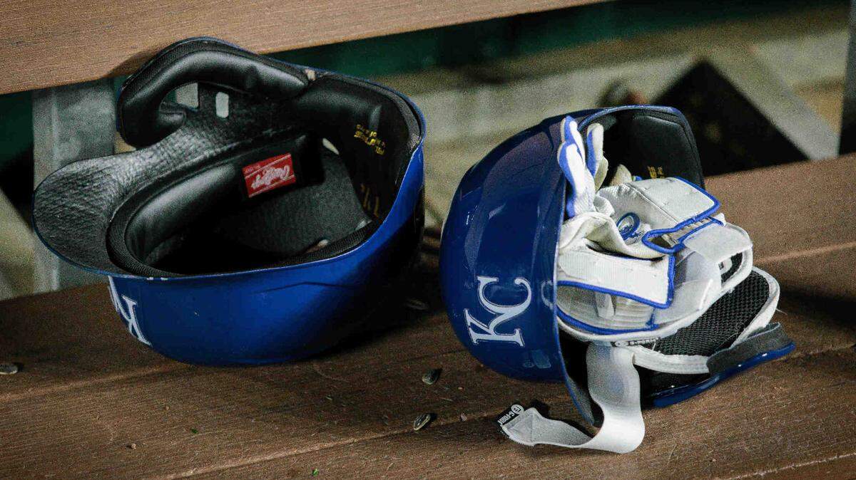 Kansas City Royals batting helmets in the dugout after a 2024 game against the Houston Astros at Kauffman Stadium.