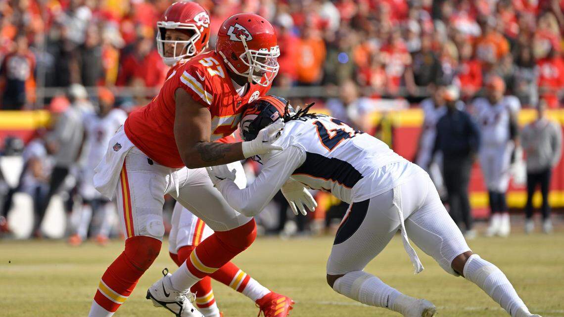 Kansas City Chiefs tackle Orlando Brown (57) blocks Denver Broncos defensive lineman Nik Bonitto (42) as Chiefs quarterback Patrick Mahomes (15) looks for an open receiver on Sunday, Jan. 1, 2023, at GEHA Field at Arrowhead Stadium in Kansas City.