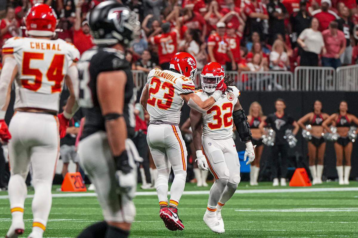 Chiefs linebacker Nick Bolton (No. 32) gets some love from teammate Drue Tranquill after stopping the Atlanta Falcons on fourth down to effectively seal KC’s Sunday night win at Mercedes-Benz Stadium.