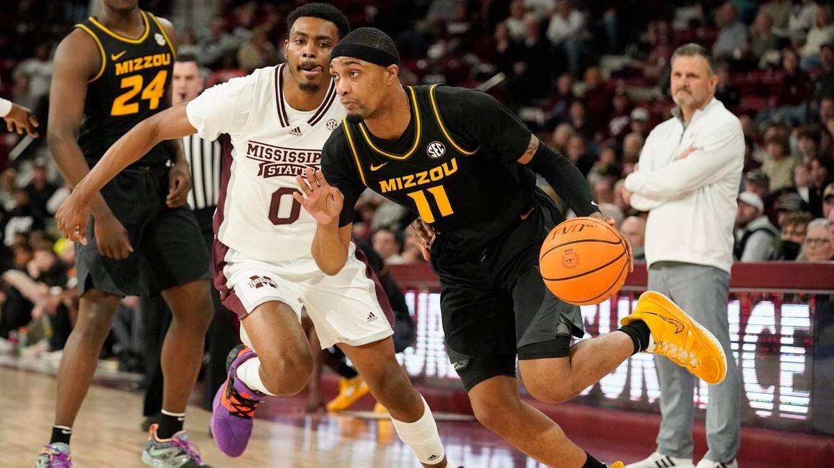 Missouri guard Isiaih Mosley (11) dribbles past Mississippi State forward D.J. Jeffries (0) during a game in Starkville, Miss., Saturday, Feb. 4, 2023.