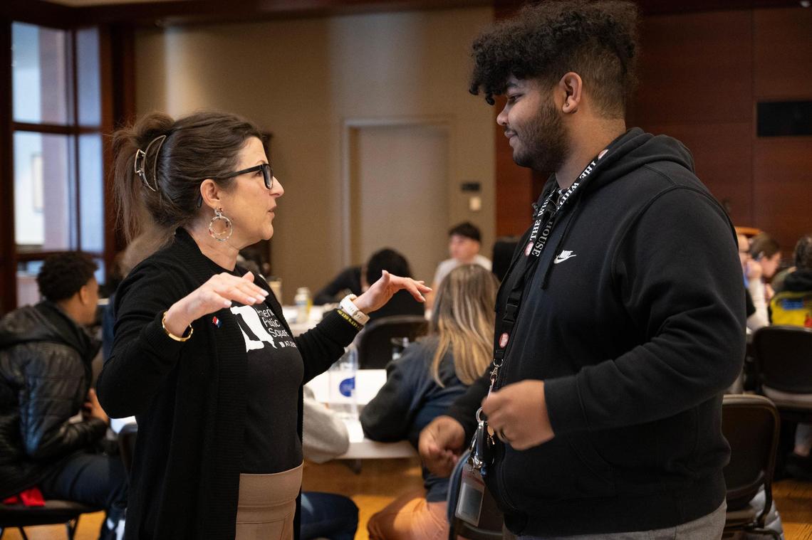 Tricia Maxfield, American Public Square program manager, speaks with DJ Yearwood, right, a youth advocate, before Yearwood addressed a group of high school students at a youth event hosted by American Public Square on Wednesday, Feb. 28, 2024, at the Central Library in Downtown Kansas City. The event was a recruiting event for Yearwood who would like to get more young adults involved in civic engagement and in the KC Youth and Young Adult Commissions.