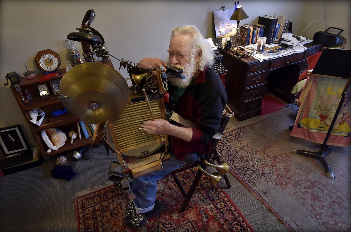 Navy veteran Bill “Jazzbo” Hargrave puts in some practice recently on his one-man-band contraption that features horns, a drum, harmonica, cowbell and layers of brass cymbals, to name a few. “This place is a managerie, and I mean that in a good way,” Hargrave said of St. Michael’s apartments.