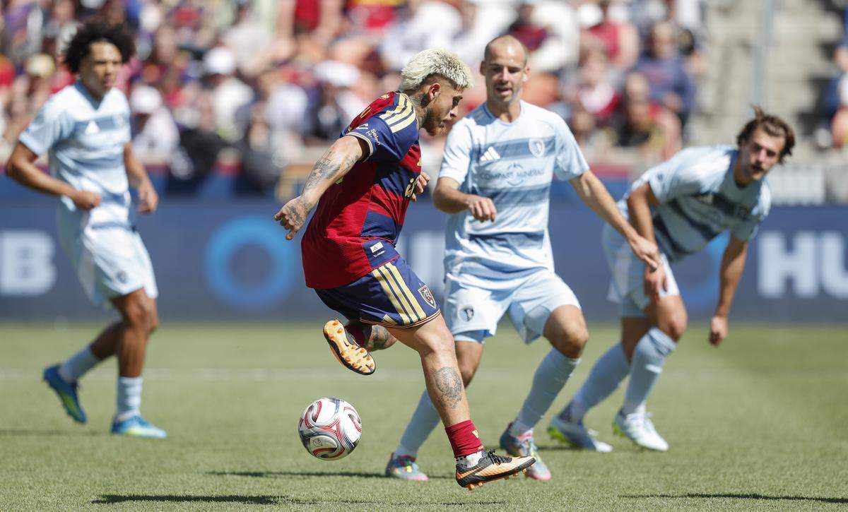 Real Salt Lake’s Diego Luna, at fore, flicks a pass past Sporting KC’s Jansen Miller during a Major League Soccer match at America First Field in Sandy, Utah on Saturday, April 4, 2026.