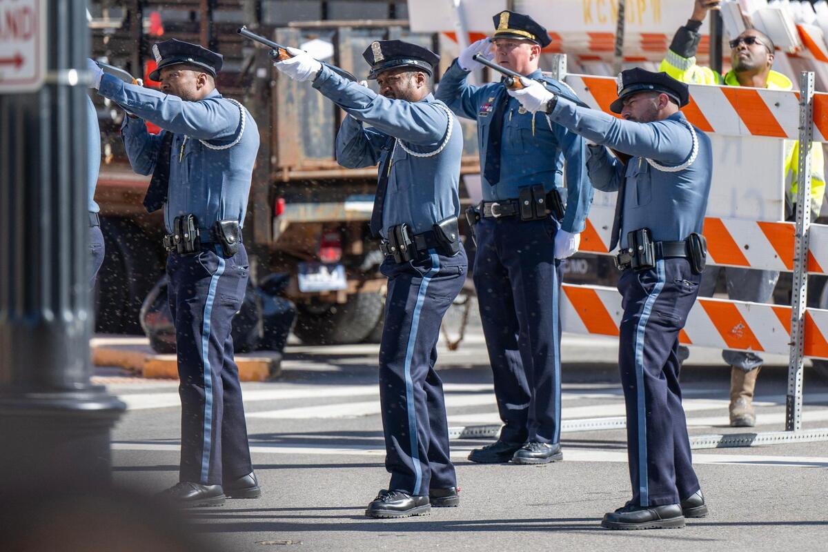 Kansas City Police officers give a gun salute during a memorial service for Drexel Mack, a civil process officer with Jackson County courts who was shot and killed during an eviction, at the Jackson County Courthouse on Monday, March 11, 2024, in Kansas City.