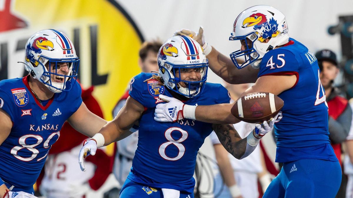 Kansas Jayhawks running back Ky Thomas (No. 8) celebrates with tight ends Mason Fairchild (89) and Trevor Kardell (45) after scoring a touchdown during Wednesday evening’s Liberty Bowl in Memphis, Tennessee.