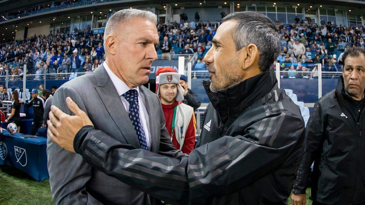 Sporting Kansas City coach Peter Vermes, left, greets interim Real Salt Lake coach Pablo Mastroeni Sunday evening on the occasion of their team’s regular-season MLS finale at Children’s Mercy Park.