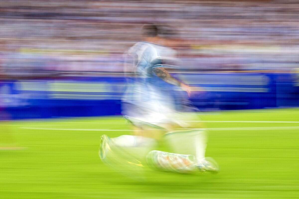 Motion blur shows Argentina forward Lionel Messi (10) races upfield with the ball during overtime against Switzerland in the FIFA World Cup quarterfinal at Kansas City (Arrowhead) Stadium on Saturday, July 11, 2026.