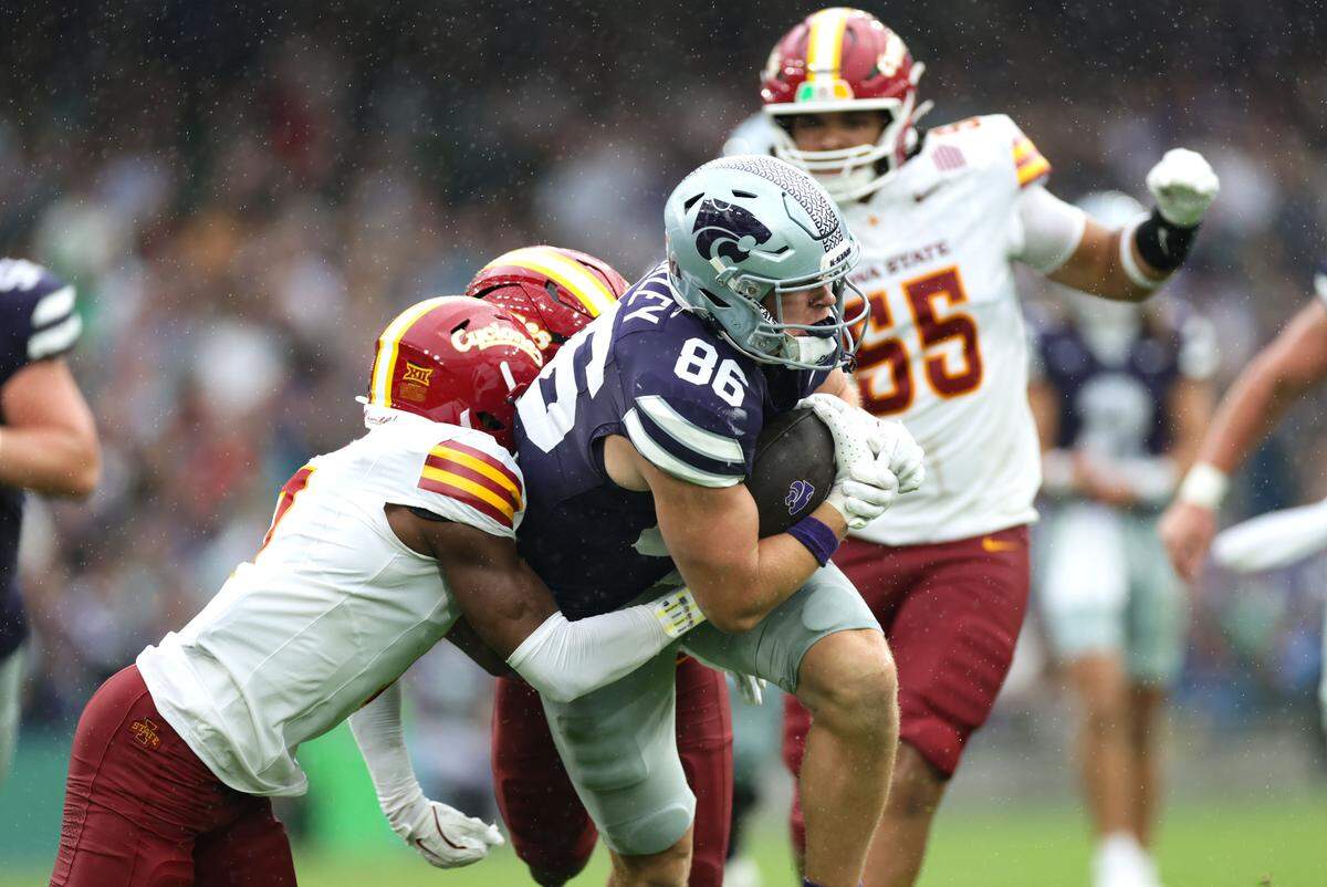 Kansas State tight end Garrett Oakley is tackled by Iowa State’s Tre Bell during the Aer Lingus Classic between Iowa State and Kansas State at Aviva Stadium in Dublin on Aug. 23, 2025.