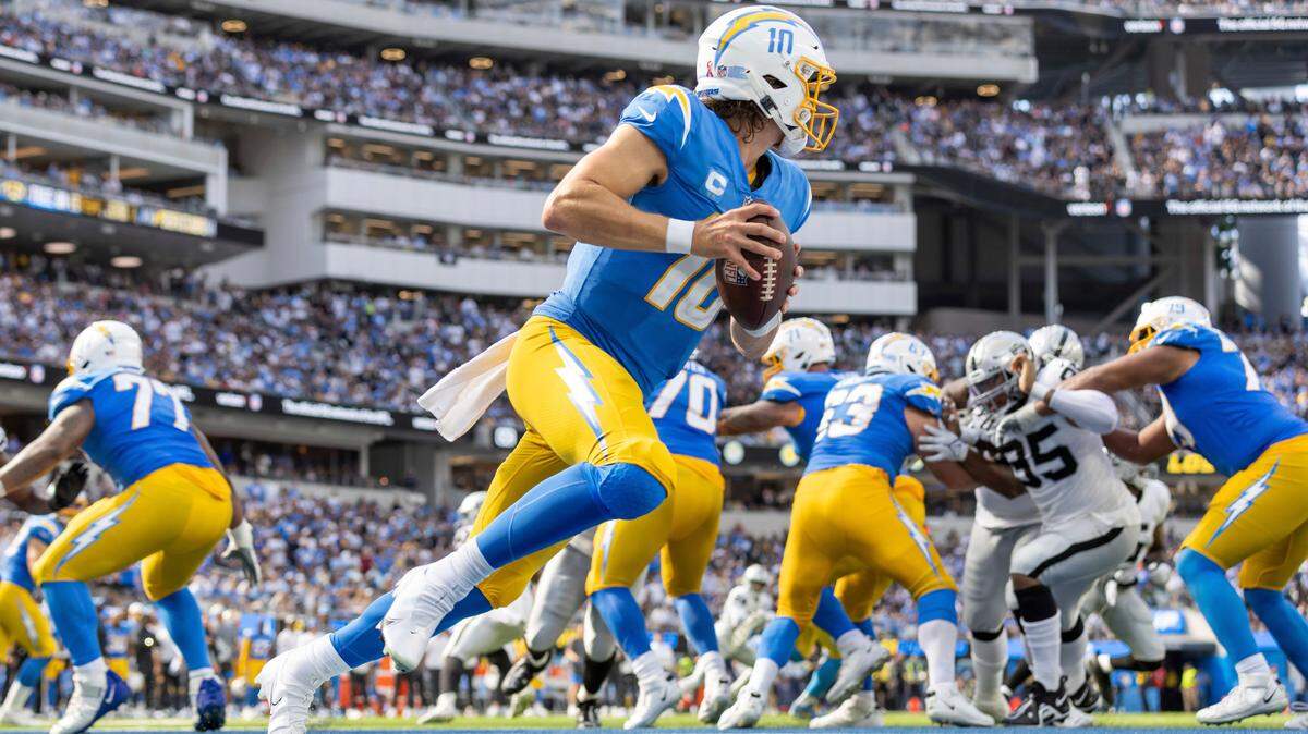 Quarterback (10) Justin Herbert of the Los Angeles Chargers rolls out against t he Las Vegas Raiders in an NFL football game, Sunday, Sept. 11, 2022, in Inglewood, Calif. Chargers won 24-19. (AP Photo/Jeff Lewis)