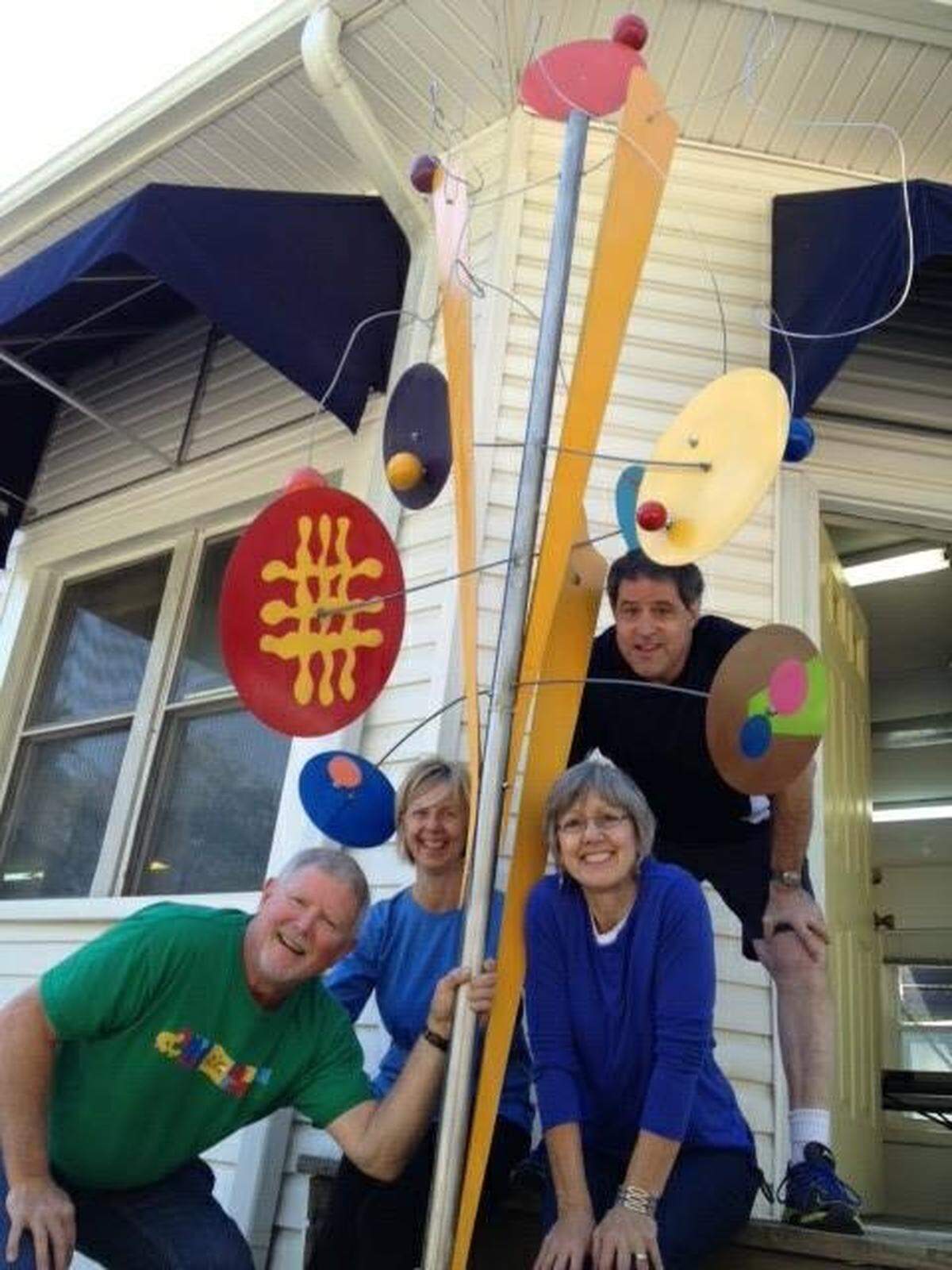 Bob Stone, left, shows off his “Penny Candy” sculpture outside the Buena Vista Art Studio with, from left, wife Patti King Stone, studio owner Ellen Sweeney and husband Mike Sweeney.