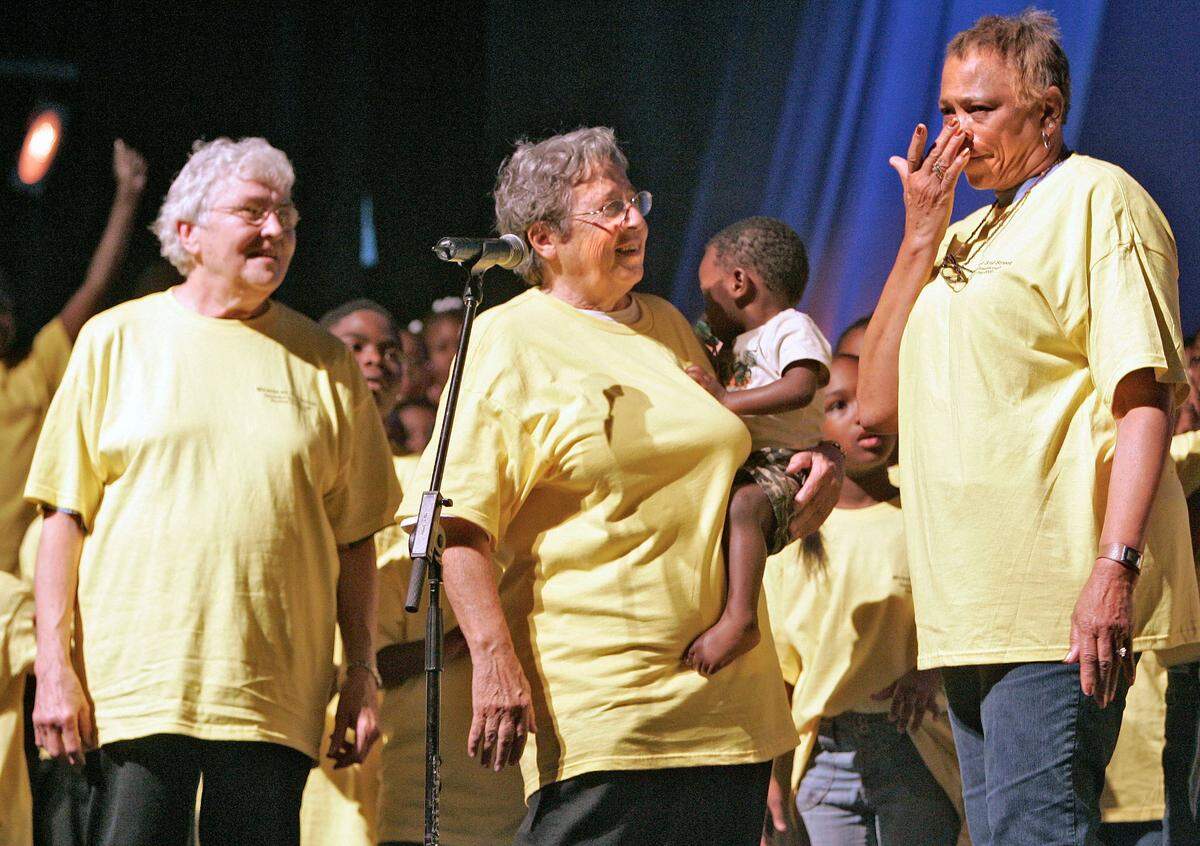Sister Corita Bussanmas, left, and Sister Berta Sailer, center, watch Connie Crumble wipe tears from her face after the performance of Miracle on 31st Street in 2005. Miracle on 31st Street was a show presenting the history of Operation Breakthrough/St. Vincent’s Family Services Center.