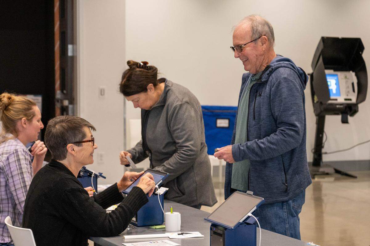 A poll worker assists a voter on Election Day, Tuesday, Nov. 4, 2025, at Johnson County Arts and Heritage Center in Overland Park.