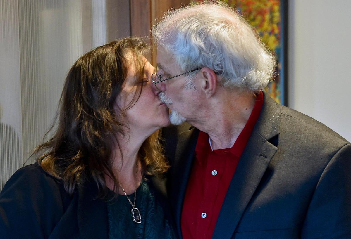 At his attorney’s office, Olin “Pete” Coones kisses his wife Deirdre Coones. A Wyandotte County judge vacated the 2009 murder conviction of Coones, who says he was framed in a 2008 double shooting of Kathleen and Carl Schroll that was actually a murder-suicide. Coones, who spent 12 years behind bars, was released Nov. 5, 2020.