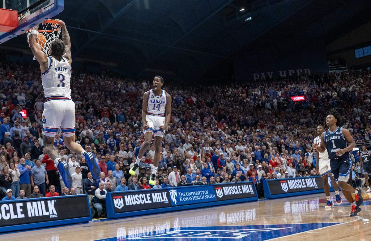 Kansas Jayhawks guard Tre White (3) slams a dunk as Melvin Council Jr. (14) reacts in the second half against the BYU Cougars at Allen Fieldhouse on Saturday, Jan. 31, 2026, in Lawrence.