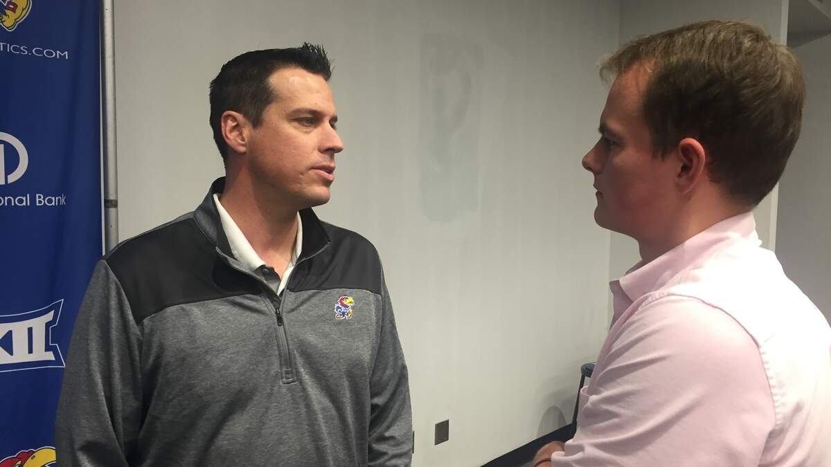 Kansas defensive coordinator D.J. Eliot, left, talks to a reporter during an interview session on Feb. 6, 2019, at the KU’s Anderson Family Football Complex.