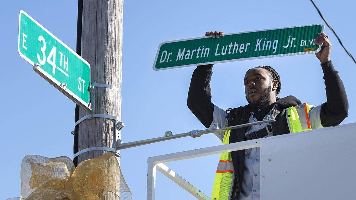 DeAnthony Jackson handled the ceremonial installation of the first new Dr. Martin Luther King, Jr. Boulevard street sign on Feb. 25, 2019 at 34th Street and The Paseo in Kansas City. The Paseo was renamed to honor King.