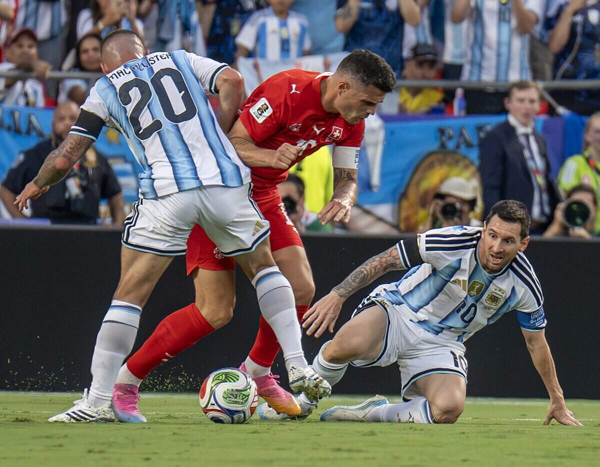 Argentina forward Lionel Messi (10) loses possession of the ball to Switzerland midfielder Granit Xhaka (10) during the first half of the FIFA World Cup quarterfinal at Kansas City (Arrowhead) Stadium on Saturday, July 11, 2026.