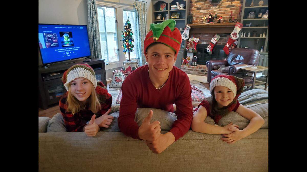 Max and the Pflumms’ two daughters watching television in the family living room over the holidays.