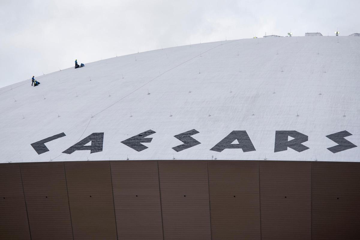 Workers work atop the Caesars Superdome in New Orleans ahead of the Super Bowl on Thursday, Jan. 30. The Kansas City Chiefs and Philadelphia Eagles will play there Sunday, Feb. 9.